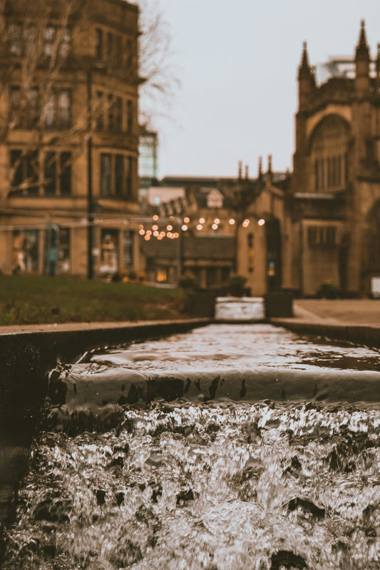 a water fountain in front of a large building