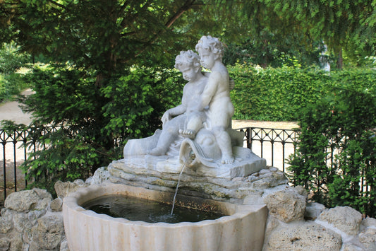 a statue of a person holding a spear in a fountain