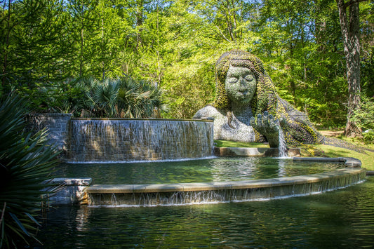 a water fountain with a statue in the middle of it