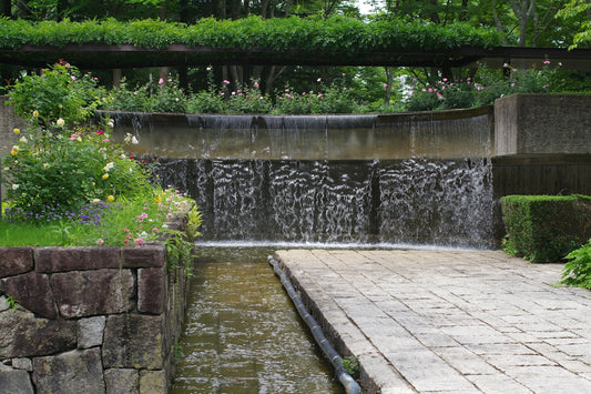 A small waterfall in the middle of a garden