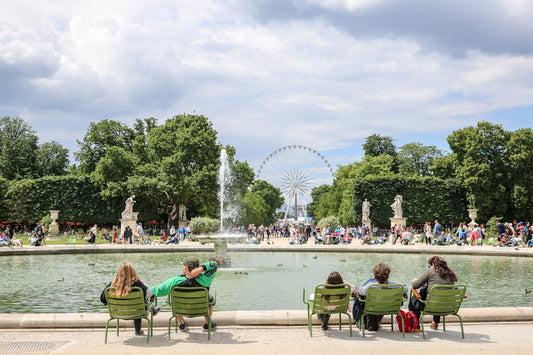 people sitting in chairs in front of a fountain