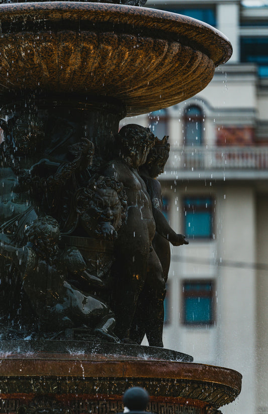 A beautiful statue fountain with water falling.
