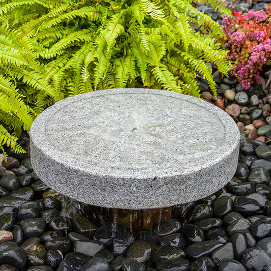 Angled Millstone Granite Stone Fountain with water flowing