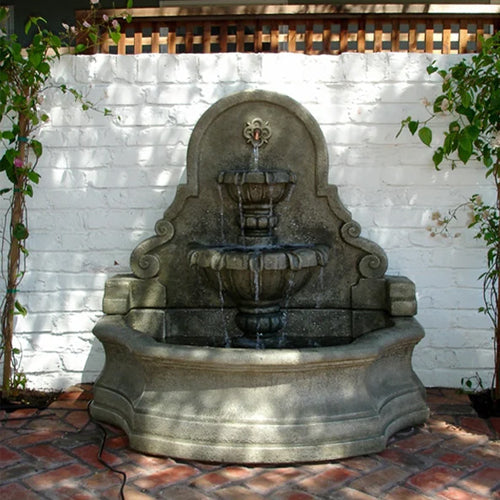 Chateau Wall Fountain with ornate carvings and water flowing into a basin
